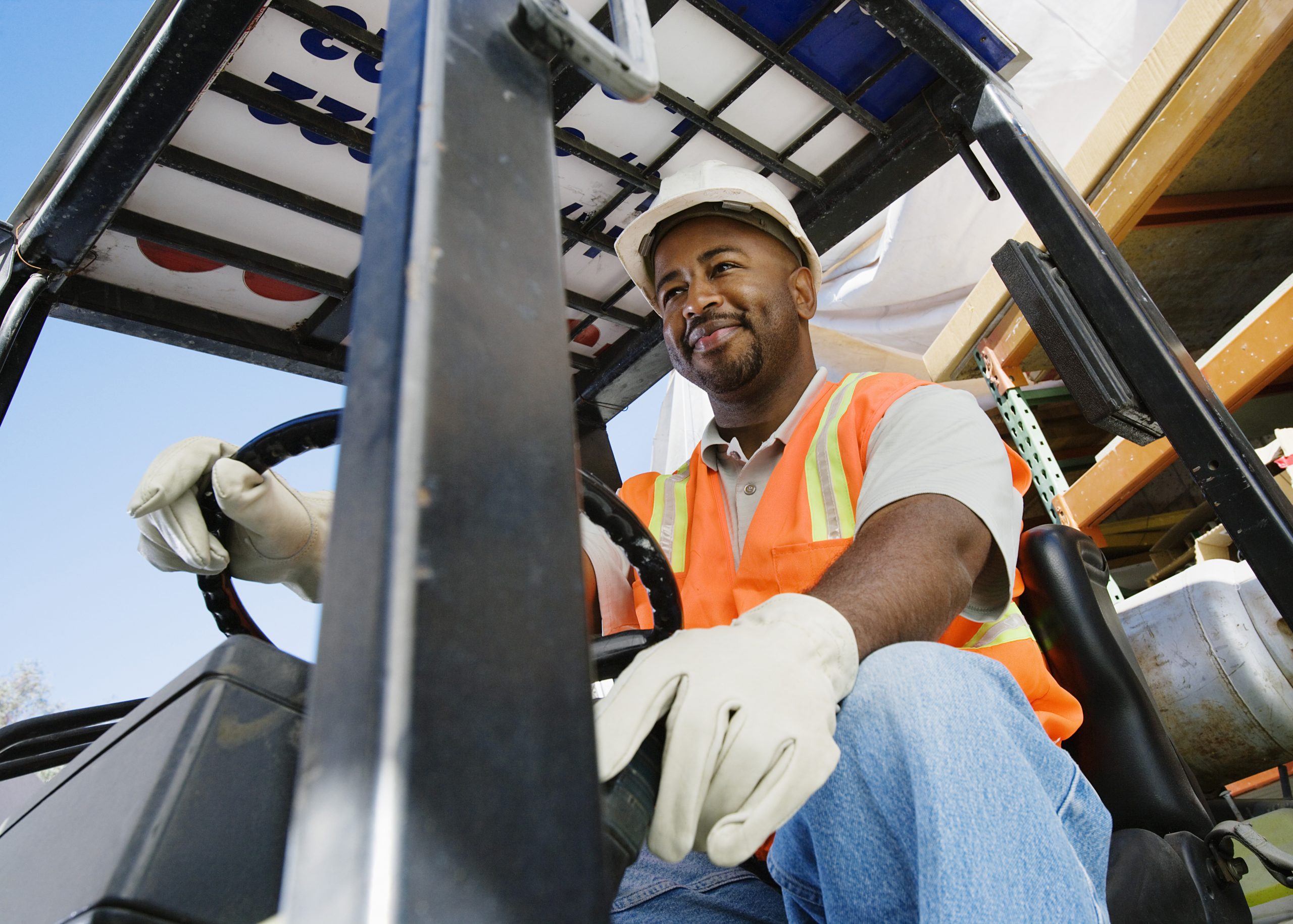 Image of a man operating a forklift. Links to the Bank of Versailles Commercial Loans page.