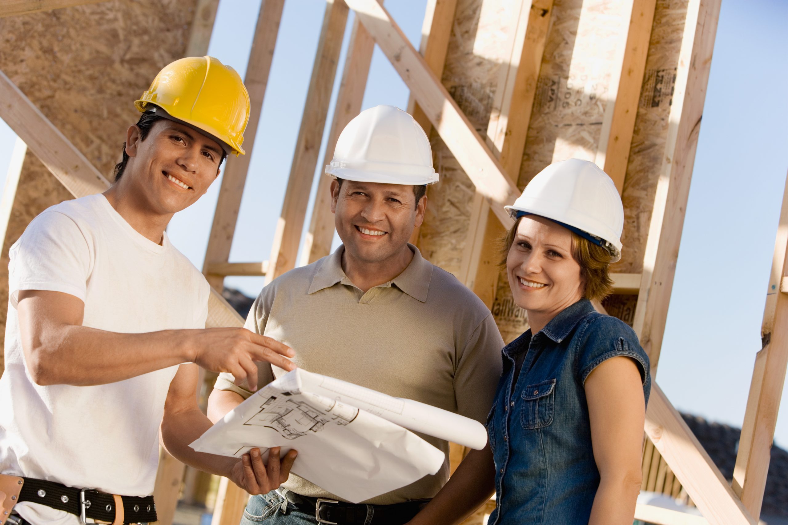 Builder and home owners reviewing home construction plans.