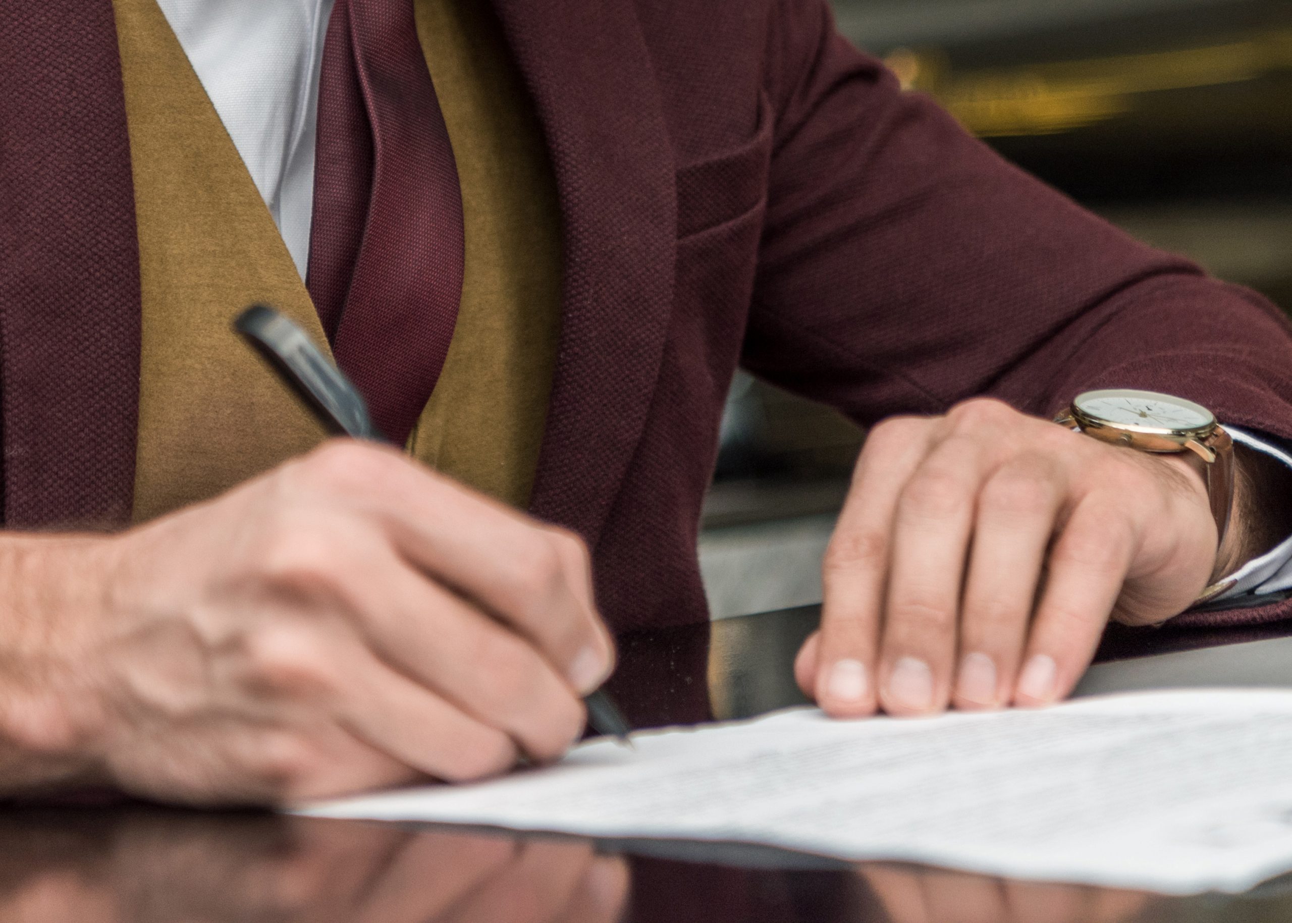 Man signing paper.