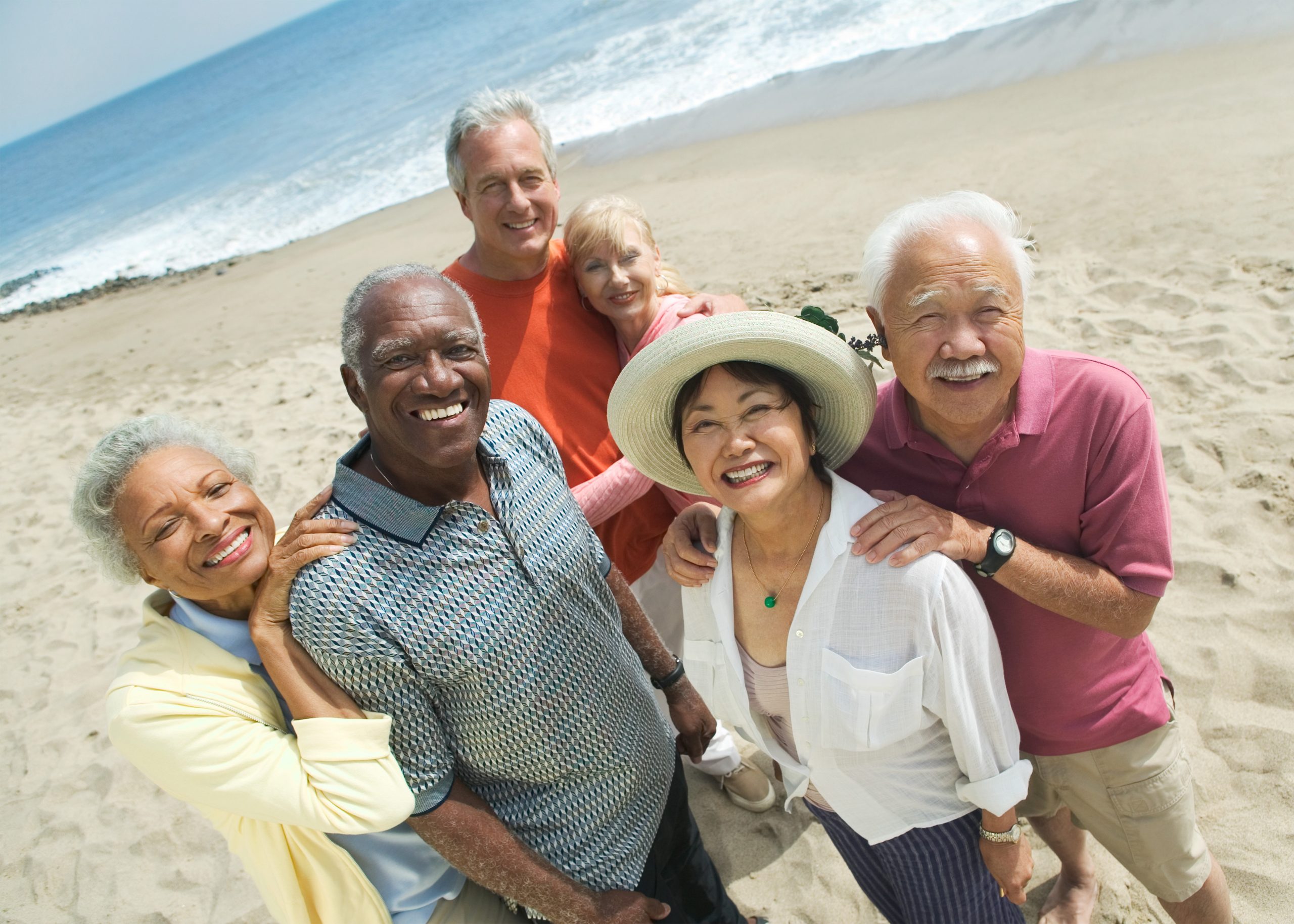 Group of mature, multicultural friends on the beach